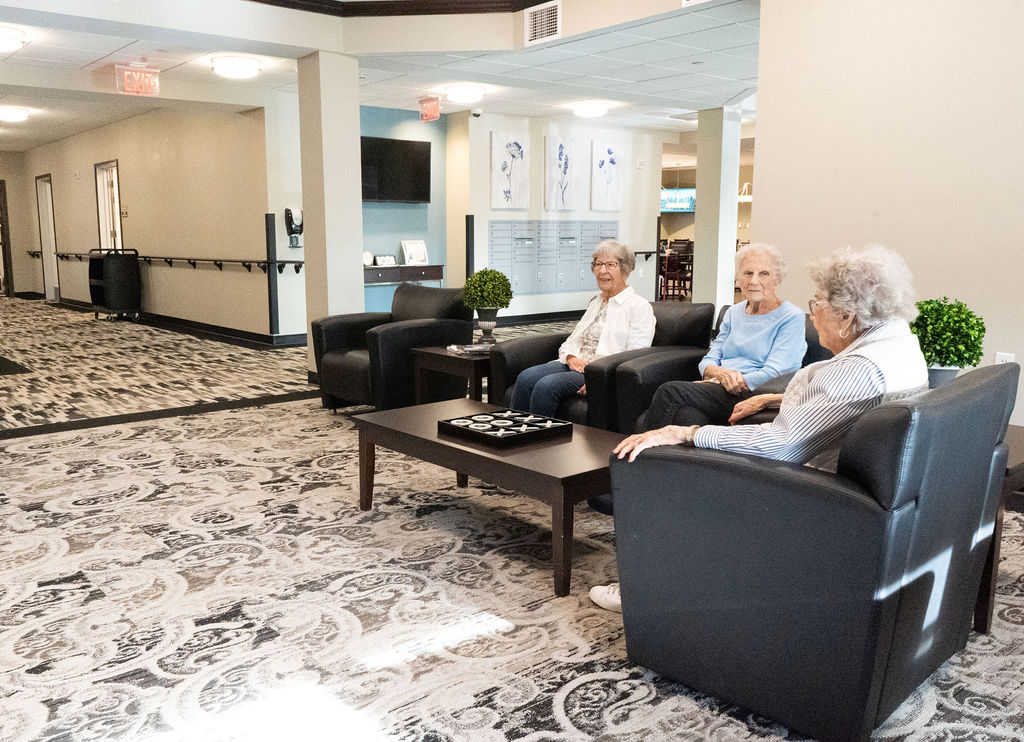 Three elderly people sitting